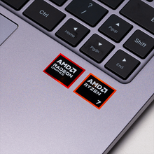 Load image into Gallery viewer, Close-up of Lunar 14R keyboard corner showing AMD Ryzen 7 and AMD Radeon Graphics stickers on a silver chassis, with arrow.