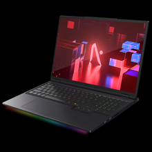 Load image into Gallery viewer, AFTERSHOCK X-16 Pro black gaming laptop angled front view with RGB keyboard and underglow, screen showing red geometric.