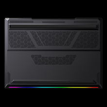 Load image into Gallery viewer, Aftershock X-16 Pro underside view showing matte black chassis with geometric vent cutouts and a slim RGB light strip along.