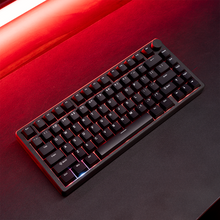 Load image into Gallery viewer, Aftershock ODEN75 Black Edition 75% wireless mechanical keyboard, angled top-down view with black keycaps, stepped volume.