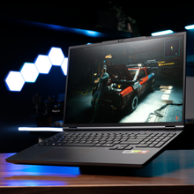 Load image into Gallery viewer, Aftershock APEX 16R laptop open at a slight angle showing 16-inch screen with a game scene, black keyboard and palm rest.